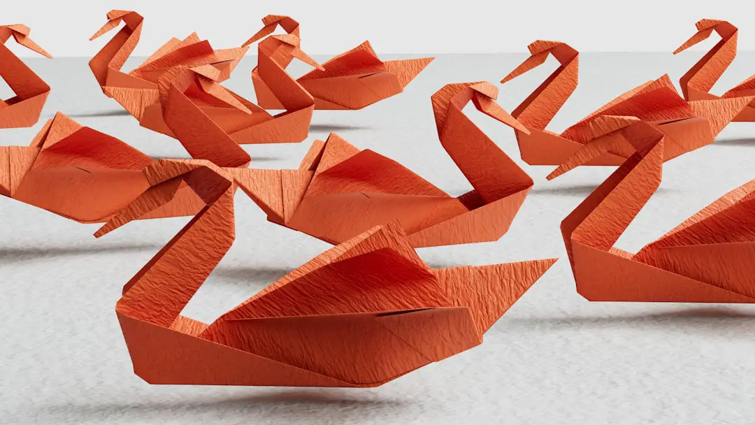Red paper swans floating above a texture. by 3D Printed a group of orange origami swans sitting on top of a table